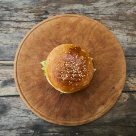 burger on round wooden tray